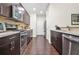 A modern kitchen featuring stainless steel appliances, sleek countertops, and dark wood cabinets at 228 Stone Park Dr, Woodstock, GA 30188