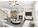 Cozy living room with a fireplace, stylish decor, and ample natural light at 228 Stone Park Dr, Woodstock, GA 30188