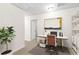 Bright office with a large desk, comfortable chair, and ample shelving for storage and display at 228 Stone Park Dr, Woodstock, GA 30188