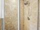 Close up of the renovated tile shower featuring an adjustable shower head and built in soap rest at 228 Stone Park Dr, Woodstock, GA 30188
