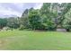 Large backyard area with lush grass and mature trees at 3072 Parks Run, Loganville, GA 30052