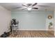 Open basement area with wood-look floors, an exercise machine, neutral paint, and a ceiling fan at 3072 Parks Run, Loganville, GA 30052