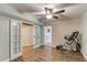 Open basement has an exercise area with neutral walls, wood-look floors, and a ceiling fan at 3072 Parks Run, Loganville, GA 30052