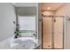Relaxing bathroom featuring a jetted tub beneath a window and a glass-enclosed shower at 3072 Parks Run, Loganville, GA 30052