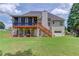 Rear exterior showing the deck, garage, and spacious yard at 3072 Parks Run, Loganville, GA 30052