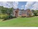 Inviting front yard featuring a well-maintained lawn and meticulously landscaped garden beds at 3072 Parks Run, Loganville, GA 30052