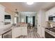 Open-concept kitchen with stainless steel appliances and granite counters connected to the dining room and living room at 3072 Parks Run, Loganville, GA 30052