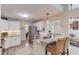 Well-lit kitchen featuring white cabinets, granite countertops, stainless steel appliances, and an adjacent dining area at 3072 Parks Run, Loganville, GA 30052