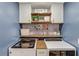 Laundry room features front-load machines, overhead cabinets, and custom-built shelving at 3072 Parks Run, Loganville, GA 30052