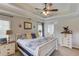 Spacious main bedroom with tray ceilings, ceiling fan, and ensuite bathroom featuring dual vanities at 3072 Parks Run, Loganville, GA 30052