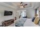 Spacious main bedroom with tray ceilings, ceiling fan, and ensuite bathroom at 3072 Parks Run, Loganville, GA 30052