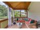 Relaxing screened porch with wicker seating, colorful pillows, and wooded views at 3072 Parks Run, Loganville, GA 30052