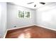 Bedroom boasts hardwood floors, a ceiling fan, and window views at 4262 Hambrick Way, Stone Mountain, GA 30083