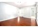 This bedroom features hardwood floors, neutral walls, and a view of the bathroom at 4262 Hambrick Way, Stone Mountain, GA 30083
