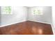 This bedroom features hardwood floors and bright windows at 4262 Hambrick Way, Stone Mountain, GA 30083