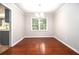 Bright dining area with hardwood floors, chandelier lighting, and a large window at 4262 Hambrick Way, Stone Mountain, GA 30083