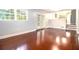 Open-concept living area with hardwood floors, neutral paint, and double glass doors at 4262 Hambrick Way, Stone Mountain, GA 30083