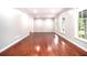 Bright living room featuring hardwood floors, neutral paint, and natural light from windows at 4262 Hambrick Way, Stone Mountain, GA 30083