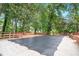 View of a spacious backyard with a covered pool and deck with wooden railing at 4262 Hambrick Way, Stone Mountain, GA 30083