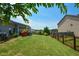 Expansive backyard featuring a well-kept lawn, defined by a wooden fence, and mature landscaping at 4265 Pleasant Woods Dr, Cumming, GA 30028
