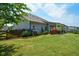Lush green backyard with mature landscaping, bordered by a charming wooden fence and featuring a covered patio at 4265 Pleasant Woods Dr, Cumming, GA 30028