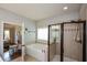 Bright bathroom featuring a soaking tub, glass-enclosed shower, and tile flooring at 4265 Pleasant Woods Dr, Cumming, GA 30028
