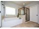 Bathroom with a soaking tub and a glass-enclosed shower at 4265 Pleasant Woods Dr, Cumming, GA 30028