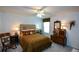 Cozy bedroom with a bed, rocking chair, dresser, and warm lighting for a relaxing retreat at 4265 Pleasant Woods Dr, Cumming, GA 30028