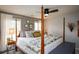 Inviting bedroom featuring a ceiling fan and a large bed with a floral-patterned comforter at 4265 Pleasant Woods Dr, Cumming, GA 30028
