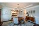 Light-filled dining area with classic furnishings and decorative china cabinet at 4265 Pleasant Woods Dr, Cumming, GA 30028