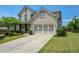 Beautiful two-story home featuring a brick facade, a spacious driveway, and manicured landscaping at 4265 Pleasant Woods Dr, Cumming, GA 30028
