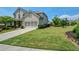 Well-manicured front yard with lush green lawn and fresh landscaping leading to a charming brick home at 4265 Pleasant Woods Dr, Cumming, GA 30028