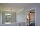 Hallway with decorative trim, a window with a view, and access to a bedroom at 4265 Pleasant Woods Dr, Cumming, GA 30028