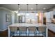 Bright kitchen features a large island with seating, stainless steel appliances, and white cabinetry at 4265 Pleasant Woods Dr, Cumming, GA 30028