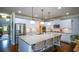 White kitchen featuring a large island with seating and stainless appliances at 4265 Pleasant Woods Dr, Cumming, GA 30028