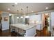 Bright eat-in kitchen island with seating and modern stainless appliances at 4265 Pleasant Woods Dr, Cumming, GA 30028
