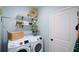 Functional laundry room with modern appliances and storage shelves at 4265 Pleasant Woods Dr, Cumming, GA 30028