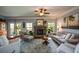 Comfortable living room offers fireplace, ceiling fan and lots of natural light at 4265 Pleasant Woods Dr, Cumming, GA 30028