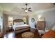 Relaxing main bedroom with hardwood floors, a ceiling fan, and soft natural light at 4265 Pleasant Woods Dr, Cumming, GA 30028