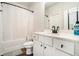 Bright bathroom with a shower-tub combination, white vanity with black fixtures, and tiled floors at 122 Riverbirch Way, Dallas, GA 30157
