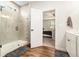 Stylish bathroom with a tiled shower, wood floors, and a view into the bedroom at 122 Riverbirch Way, Dallas, GA 30157
