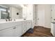 Bathroom featuring double sinks with white cabinets and wood look floors at 122 Riverbirch Way, Dallas, GA 30157