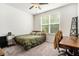 Cozy bedroom features a wooden bed frame, large window, and functional desk area at 122 Riverbirch Way, Dallas, GA 30157