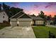 Charming one-story home with a two-car garage and inviting curb appeal, set against a colorful sunset backdrop at 122 Riverbirch Way, Dallas, GA 30157