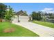Beautiful one-story home with a well-manicured lawn and a long driveway leading to a spacious two-car garage at 122 Riverbirch Way, Dallas, GA 30157