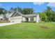 Well-maintained one-story home featuring a lush green lawn and a convenient two-car garage, enhancing its appeal at 122 Riverbirch Way, Dallas, GA 30157