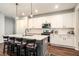 Modern eat-in kitchen featuring a kitchen island with barstool seating, stainless steel appliances, and ample counter space at 122 Riverbirch Way, Dallas, GA 30157