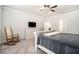 Spacious main bedroom featuring a ceiling fan, rocking chair, and carpeted floor at 122 Riverbirch Way, Dallas, GA 30157