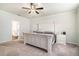 Cozy main bedroom featuring a ceiling fan, large bed, and carpeted floor at 122 Riverbirch Way, Dallas, GA 30157