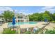 Luxurious community pool with a clubhouse, lounge chairs, and manicured greenery at 122 Riverbirch Way, Dallas, GA 30157